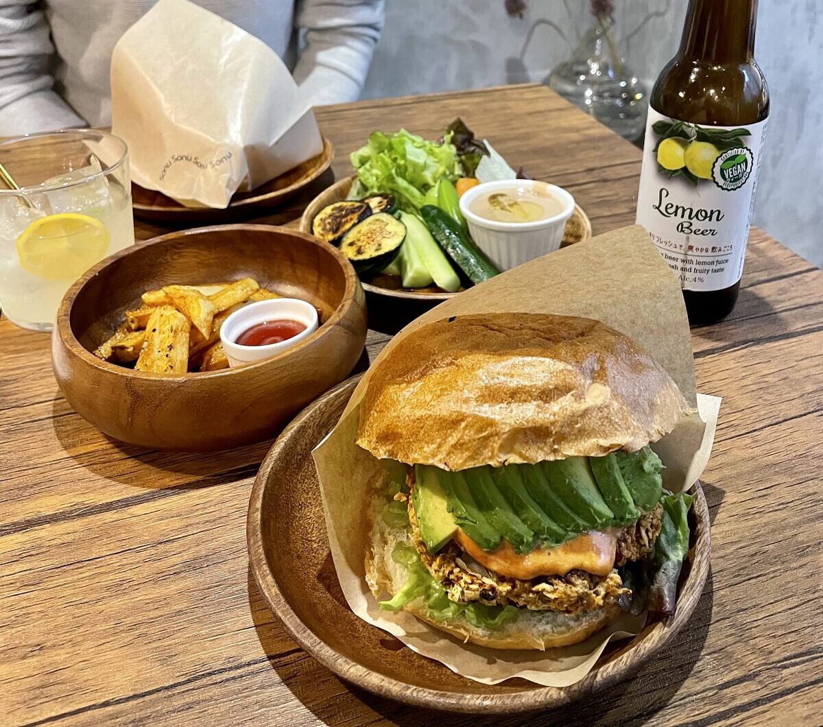 Avocado burger with fries and vegan lemon beer at Sonu Sonu, one of the best vegan restaurants Fukuoka has