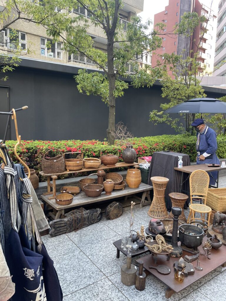 Tokyo flea market stall with bamboo baskets, iron kettles and indigo textiles at the Tokyo Romantic Market in Shibuya