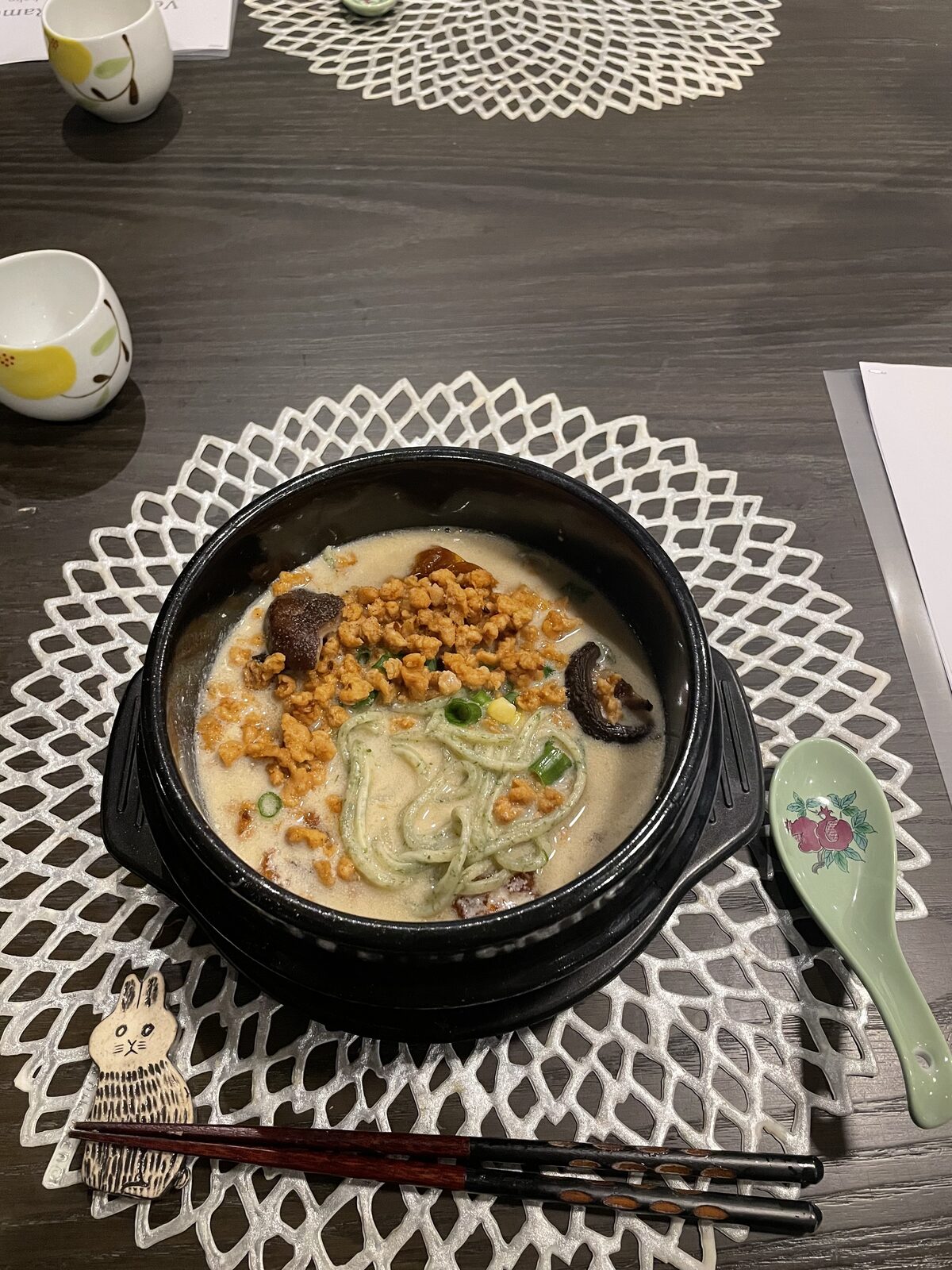 Vegan ramen broth with miso, homemade green noodles, soy mince, corn and green onions at a ramen cooking class in Tokyo